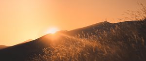 Preview wallpaper sunset, slope, sun, hill, rays