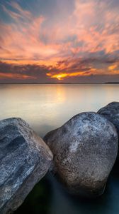 Preview wallpaper sunset, stone, sun, sea, horizon