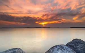 Preview wallpaper sunset, stone, sun, sea, horizon