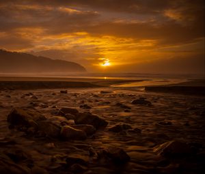 Preview wallpaper sunset, stone, water, waves