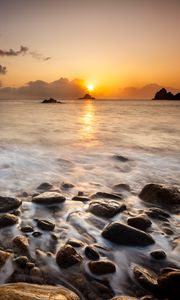 Preview wallpaper sunset, stones, pebbles, sea, horizon