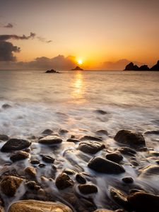 Preview wallpaper sunset, stones, pebbles, sea, horizon