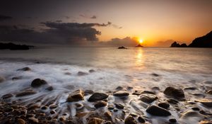 Preview wallpaper sunset, stones, pebbles, sea, horizon