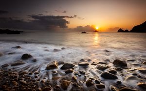 Preview wallpaper sunset, stones, pebbles, sea, horizon