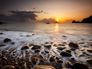 Preview wallpaper sunset, stones, pebbles, sea, horizon