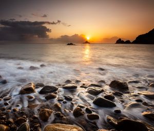 Preview wallpaper sunset, stones, pebbles, sea, horizon