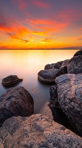 Preview wallpaper sunset, stones, rocks, horizon, sea