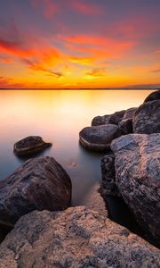 Preview wallpaper sunset, stones, rocks, horizon, sea
