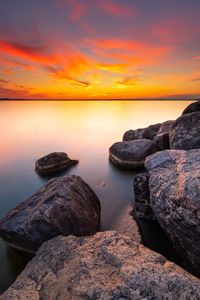 Preview wallpaper sunset, stones, rocks, horizon, sea