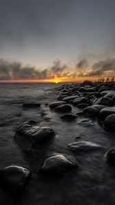 Preview wallpaper sunset, stones, sea, water, horizon, sky
