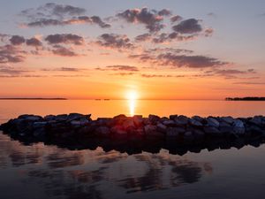 Preview wallpaper sunset, stones, sea, horizon, sky