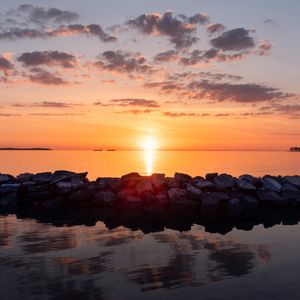 Preview wallpaper sunset, stones, sea, horizon, sky