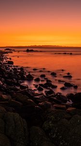 Preview wallpaper sunset, stones, water, horizon