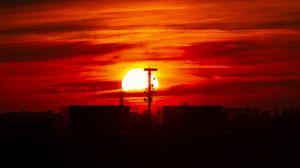 Preview wallpaper sunset, sun, buildings, city, sky