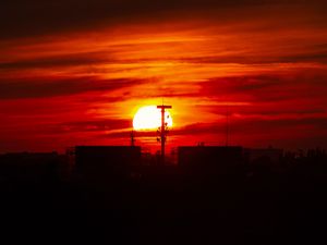 Preview wallpaper sunset, sun, buildings, city, sky