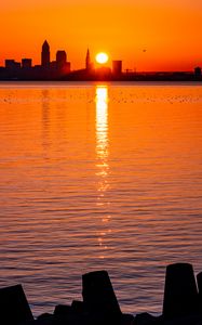 Preview wallpaper sunset, sun, city, silhouettes, water, dark