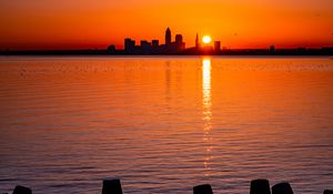 Preview wallpaper sunset, sun, city, silhouettes, water, dark