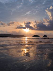 Preview wallpaper sunset, sun, glare, sea, clouds