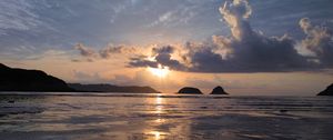 Preview wallpaper sunset, sun, glare, sea, clouds