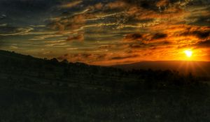 Preview wallpaper sunset, sun, hills, landscape, trees, nature