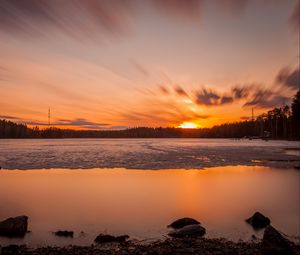 Preview wallpaper sunset, sun, lake, ice, stones