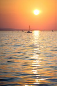 Preview wallpaper sunset, sun, ocean, boats, horizon