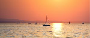 Preview wallpaper sunset, sun, ocean, boats, horizon