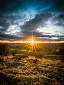 Preview wallpaper sunset, sun, rays, light, field, landscape