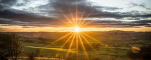 Preview wallpaper sunset, sun, rays, light, field, landscape