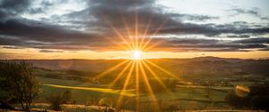 Preview wallpaper sunset, sun, rays, light, field, landscape