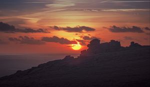 Preview wallpaper sunset, sun, rocks, stone, clouds