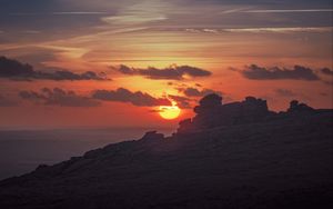 Preview wallpaper sunset, sun, rocks, stone, clouds