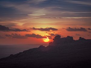 Preview wallpaper sunset, sun, rocks, stone, clouds