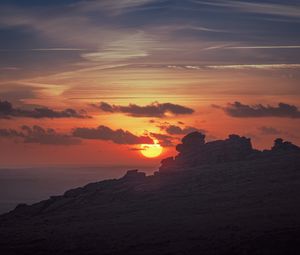 Preview wallpaper sunset, sun, rocks, stone, clouds