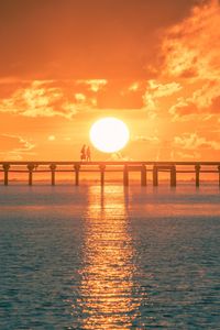 Preview wallpaper sunset, sun, silhouette, bridge, sea, glare