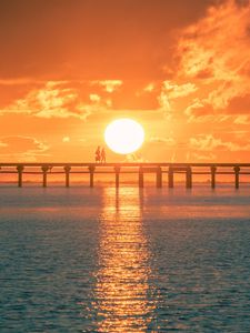 Preview wallpaper sunset, sun, silhouette, bridge, sea, glare