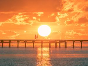 Preview wallpaper sunset, sun, silhouette, bridge, sea, glare