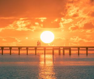 Preview wallpaper sunset, sun, silhouette, bridge, sea, glare
