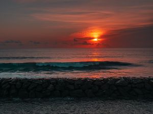 Preview wallpaper sunset, sun, stones, sea, waves