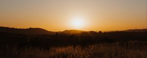 Preview wallpaper sunset, the sun, rays, vast, hills