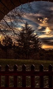 Preview wallpaper sunset, trees, fence, arch