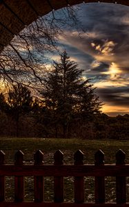 Preview wallpaper sunset, trees, fence, arch