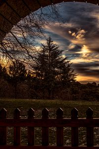 Preview wallpaper sunset, trees, fence, arch