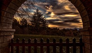 Preview wallpaper sunset, trees, fence, arch