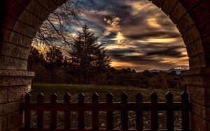 Preview wallpaper sunset, trees, fence, arch