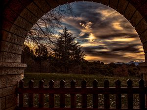 Preview wallpaper sunset, trees, fence, arch