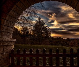 Preview wallpaper sunset, trees, fence, arch