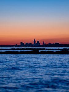 Preview wallpaper sunset, water, city, buildings, silhouettes, dark