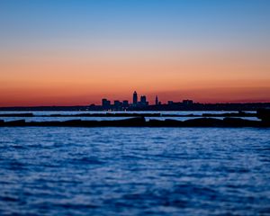 Preview wallpaper sunset, water, city, buildings, silhouettes, dark