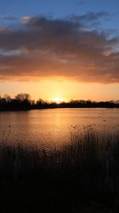 Preview wallpaper sunset, water, glare, grass